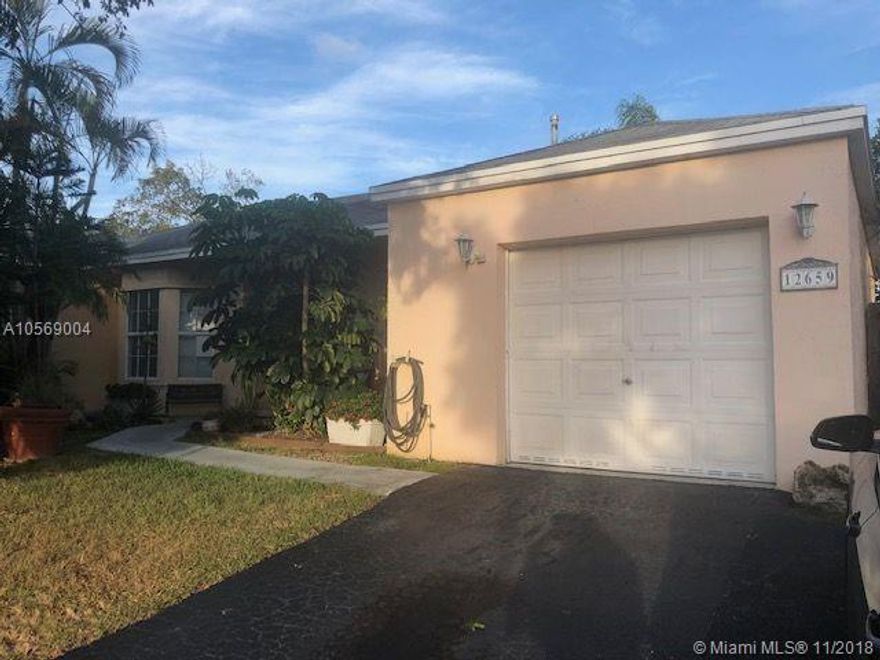 Own this charming well maintained 3/2/1 in family oriented Deerwood Villas! Located near turnpike, Metro Zoo, shopping, schools and dining. Property boast of larger lot with concrete driveway in back yard for boat or r.v., A/C  8 years old. Bright open kitchen with breakfast nook, tile floors in living and 1 bedroom, stunning hardwood in master bedroom, wood laminate in 2nd bdrm.,bay window, screened patio, garden path, shed, and Jacuzzi tub. Enjoy LOW MONTHLY FEE , community pool, spa, tennis courts, playground, b.b.q. and onsite SECURITY.