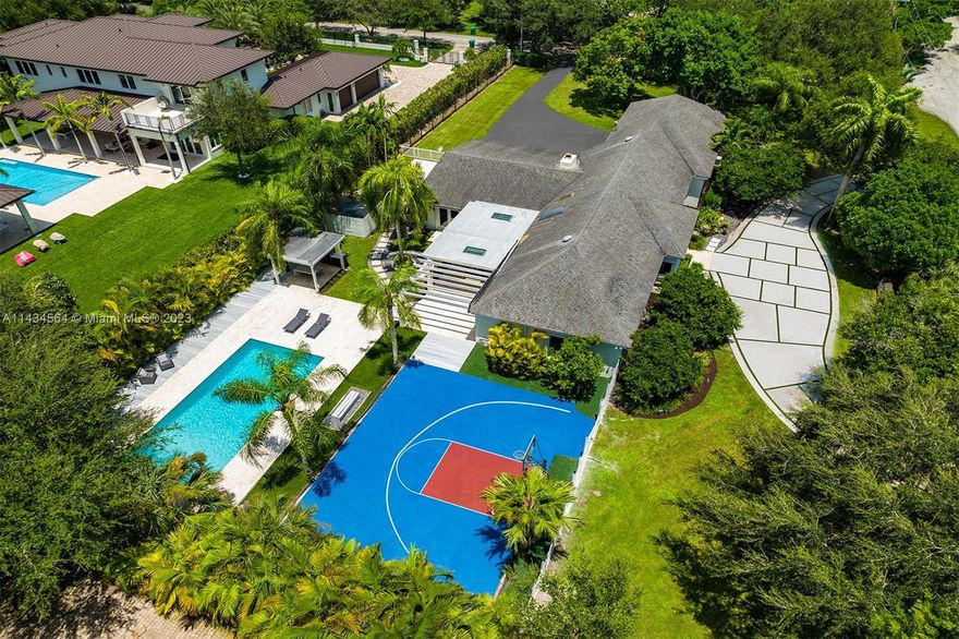 Uncover an exquisite one-story North Pinecrest gem with a half-moon basketball court. Enjoye 5 bedrooms and 4 bathrooms and sprawling entertaining spaces: formal living, dining, bar, gourmet kitchen, and a vast family room overlooking the pool. The luxurious master suite boasts a sitting area, spa-like bath, and backyard access. Outside, a serene oasis offers a covered terrace, pool, gazebo and summer kitchen. Additional features: impact windows/doors, maid’s quarters, 3-car garage, proximity to top-rated schools.