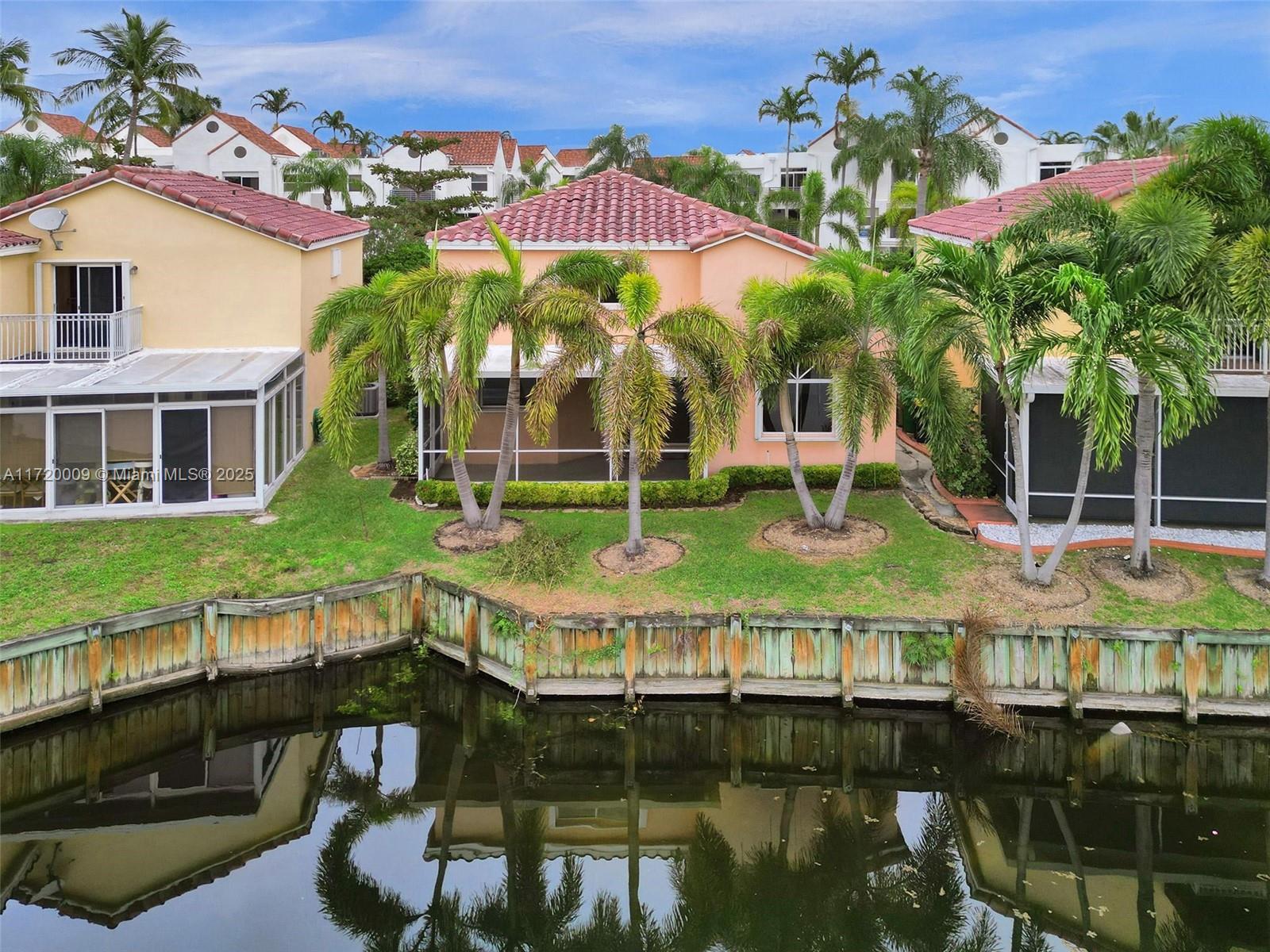 Rarely available waterfront 2-story, well-maintained home, largest floor plan, 2-car garage, located on the widest part of the lake. Open kitchen with a breathtaking lake view, ss appliances. Master bedroom overlooking the lake, dedicated laundry room, spacious screened patio with lavish landscaping, newly installed wood floors, vaulted ceilings, freshly painted, new AC (2022) and water heater (2019), lots of natural light, the home is ready for move-in! Highly desirable boutique, pet-friendly and well-managed gated community with low maintenance fee, has a community pool. Just minutes away from the beach, West Lake Park & Ann Kolb Nature Center. Conveniently situated east of US1, around the corner from the newly-built Dania Pointe, featuring the finest dining, shopping & entertainment.