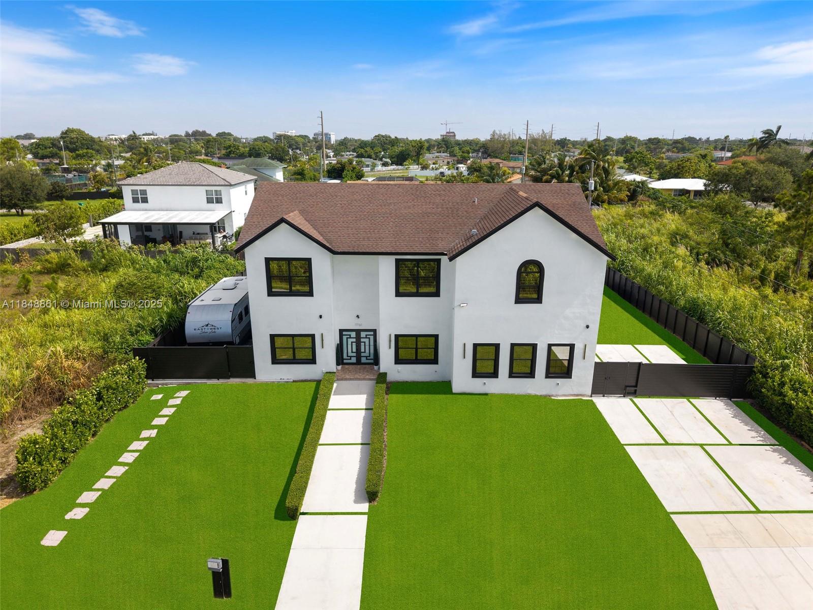 Nestled in a quiet neighborhood with minimal neighbors, this stunning 2012-built home features 5 bedrooms + den, 4.5 baths, and sits on an oversized 11,200 sqft lot. A separate 1 bed/1 bath offers ideal space for in-laws or rental income. Filled with natural light, the home boasts impact windows throughout, a massive master suite with spa-like bath, a first-floor guest room or office, and an upstairs laundry. Enjoy a spacious 2-car garage, ample parking, and a spectacular terrace opening to a huge backyard—perfect for entertaining or relaxing. Ideally located near shopping, schools, and major highways.
