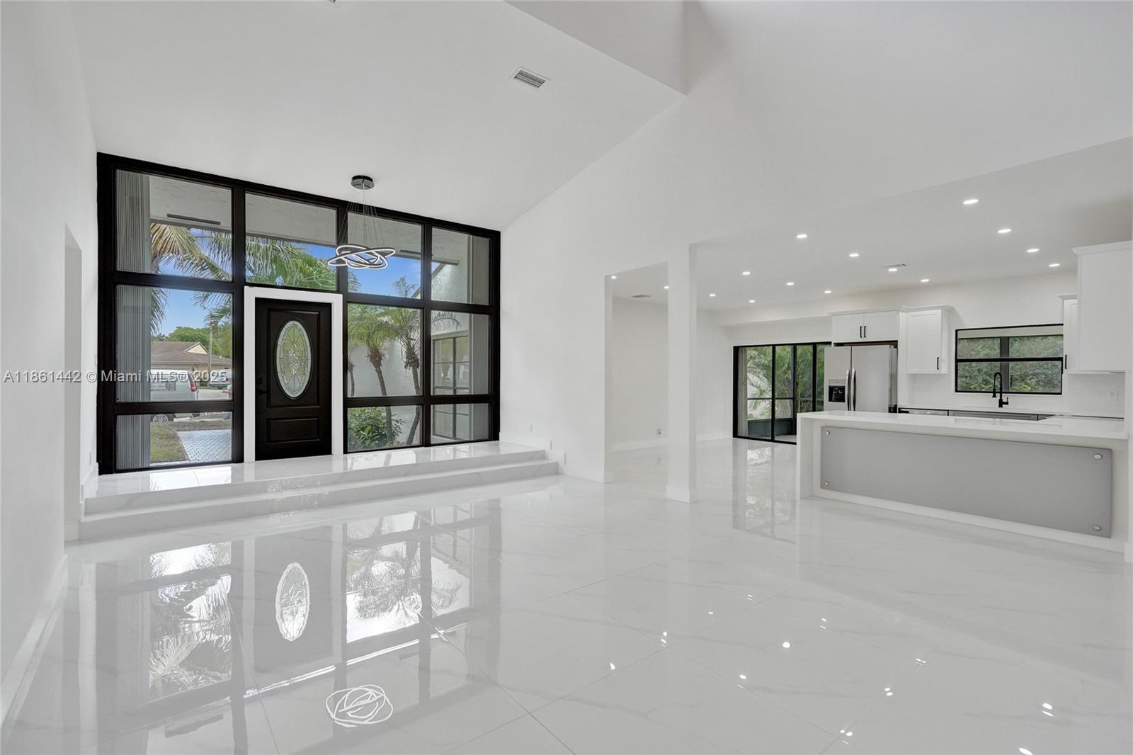 Welcome to this renovated 4-bedroom,3-bath home w/ a 2-car garage & breathtaking golf course views. Enjoy a modern, open-concept layout with soaring ceilings & an abundance of natural light.The kitchen is a chef’s dream, boasting quartz countertops, new stainless steel appliances & tile flooring. All bathrooms have been remodeled. The spacious master suite includes a large walk-in closet. Every detail has been carefully considered, from the fresh interior & exterior paint to the NEW roof installed in 2022.With Fully Paid-Off Energy-Efficient Solar Panels, reduce your FPL bill. Accordion Hurricane shutters for all windows & sliding glass doors. NO Association! Located near Woodmont Country Club, where membership includes access to golf, a pool, gym,tennis courts, pickleball,restaurant,bar.