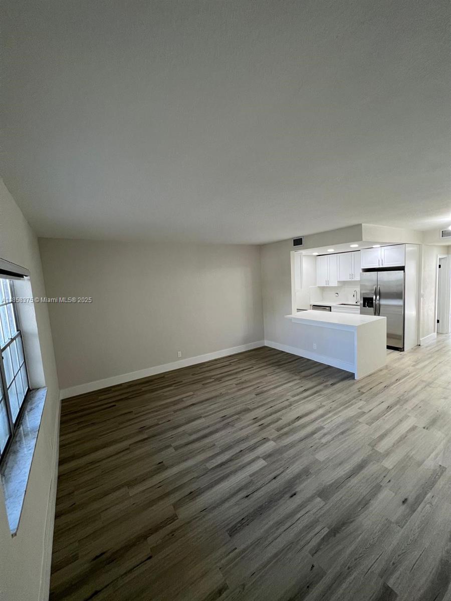 This unit is a stunning 1-bedroom, 1-bathroom residence on the first floor of a small condominium complex. It features a pantry, spacious closet, and a small storage area for your convenience. The unit has undergone a complete remodel, including stainless steel appliances in the open concept kitchen, along with new cabinets, a quartz countertop, flooring, ceiling, a central AC system, and a high-efficiency tankless water heater. You will also have the benefit of one assigned parking space. Laundry is just one door away using the back bedroom door.