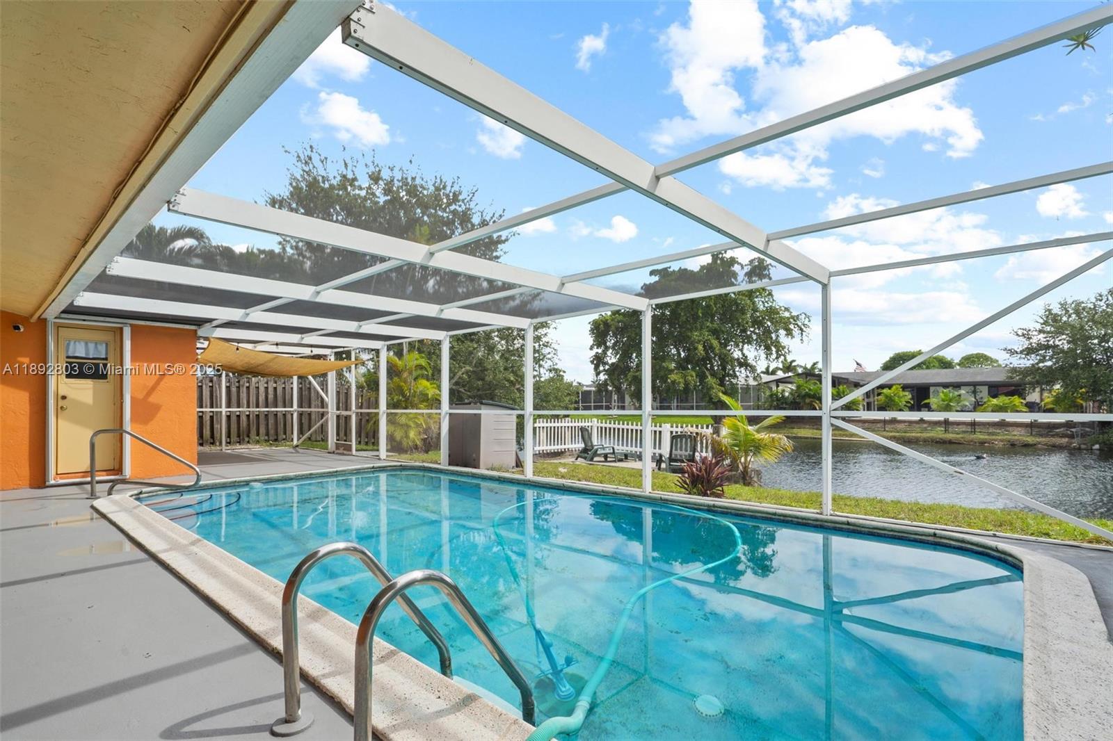 Welcome to your waterfront oasis in Sunrise Golf Village! This beautifully maintained 3-bedroom, 2-bath single-family home offers nearly 2,000 sq ft of living space and sits on a 6,900 sq ft canal-front lot with no HOA. Enjoy Florida living with a private pool, spacious deck & patio ...perfect for entertaining or relaxing by the water. Interior features include a bright, open layout with ceramic tile flooring throughout, updated kitchen appliances, and a converted garage for extra living space or storage. Located in a quiet neighborhood with a circular driveway, this home is just minutes from schools, parks, shopping, and dining. Newer roof, A/C, and water heater offer peace of mind. OK to lease – great for investors or end users!