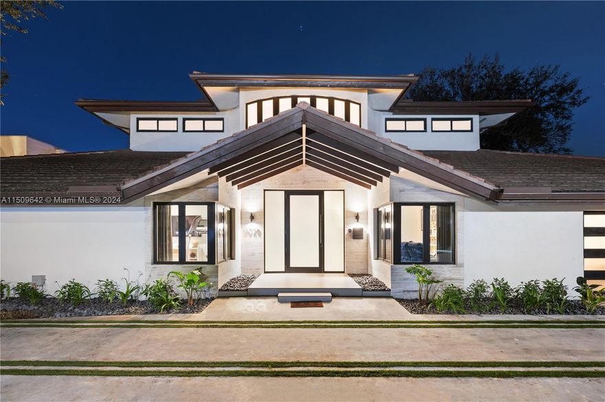 Discover unrivaled luxury at 16020 E Troon Circle in Miami Lakes' Loch Lomond. This impeccably redesigned residence offers luminous spaces and refined elegance. The main level features a formal dining room, wine closet, stone-clad fireplace, and  professionally equipped kitchen with Miele appliances and Italian finishes. With 5 beds, 5 baths, a media room, storage pantry, and maid's quarters, every detail is curated for opulence. The second floor reveals the main suite with 2 custom Snaidero wardrobes and a lavish spa. This exceptional home boasts a trim-less Kreon lighting system, Oak stairs, and naturally honed coliseum cladding, Control4 automation. Outside, enjoy your exclusive retreat feat. a modern pool and Luxapatio kitchen. Revel in sweeping sunset views from this lakefront haven.