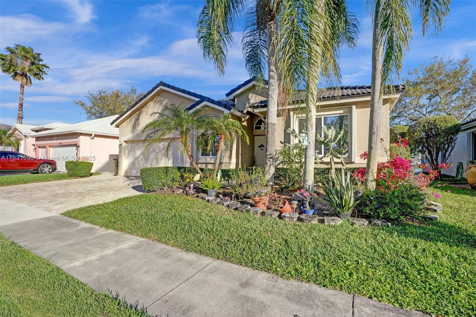 This spacious 1-story home offers serene water views from nearly every room, vaulted ceilings, crown molding, tile flooring, and a split-bedroom layout. The gourmet kitchen features custom cabinetry, stainless steel appliances, a tile backsplash, and a sleek hooded range—ideal for open-concept living. The oversized primary suite boasts two walk-in closets and a luxurious bath with a sunken tub, new glass-enclosed shower, and dual vanities. Enjoy outdoor living on the large screened patio with stunning lake views. Includes accordion shutters, a separate laundry room, flex space, and access to the community pool.