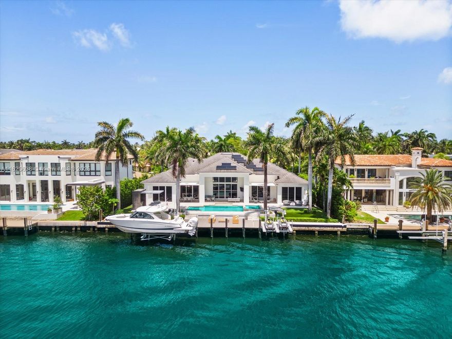 Welcome to your dream home in Golden Beach's exclusive South Island! This unique turnkey one-story residence, set on an oversized 18,975 sqft lot, features a spacious open floor plan with soaring 16 ft ceilings. Revel in stunning waterfront living with 115 ft on the water, complete with a newly built boat lift and a yacht and jet ski-equipped dock. The home boasts 6 luxurious suite bedrooms, including an oversized master suite with an outside Bali-style bathroom, a gym, and a second-floor in-law's or a teenager's dream unit . The manicured resort-like outdoor space is perfect for entertaining. Decorated to perfection and designed for the ultimate entertainer, this custom masterpiece offers unmatched amenities and is one of the most unique and desirable  properties in the neighborhood.