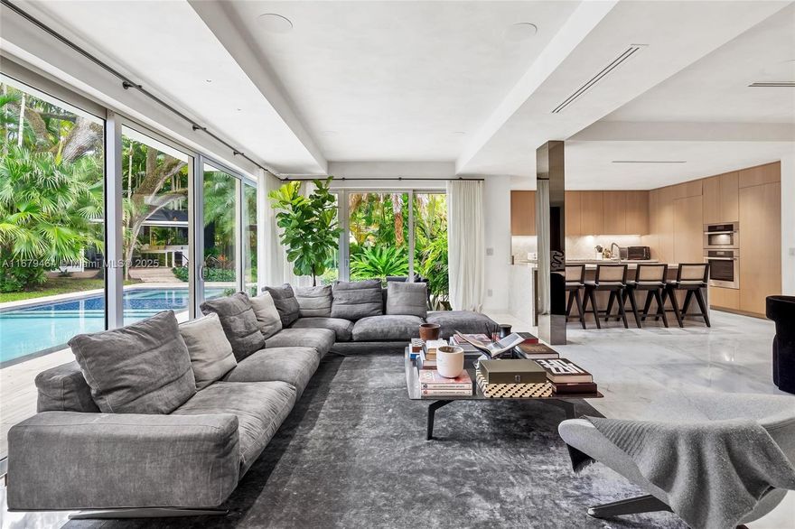 Discover a mid-century modern gem nestled in North Coconut Grove, where luxury meets comfort. This stunning 5 BD 5.5 BA home designed by Maurice Weintraub Architects and gut renovated by Architect Ralph Tait spans nearly 3500 SF and sits on a rare 13,375 SF lushly landscaped Double Lot. Recently renovated, it boasts exquisite Everest white and Carrara marble floors, brand new chef's kitchen with top-tier appliances, high ceilings & a spacious primary suite featuring European white oak floors and vaulted ceilings. The backyard offers a large pool with sunken spa, covered cabana with summer kitchen and bathroom, and a putting green. Conveniently located close to top schools , highways and the best shopping and dining that both Coconut Grove and Brickell have to offer. A rare find & must see!