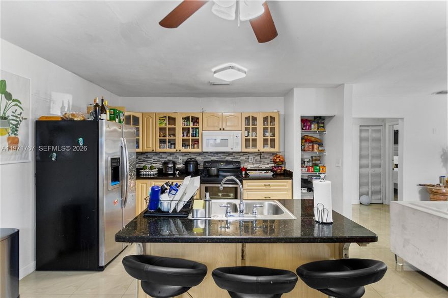 Ideal for investors or extended families, this adaptable Miami-area property offers strong potential with multiple living arrangements. The residence includes a 3-bedroom, 2-bath configuration that has been modified for flexible use, allowing the spaces to be rented separately or easily restored to a traditional single-family home. This setup is perfect for those seeking rental income, an owner-occupied option with added revenue, or a comfortable solution for multi-generational living with added privacy. With no HOA and no usage restrictions, owners have full control and flexibility. The home is move-in ready with improvements, including impact windows and doors, updated kitchens and bathrooms, approx 2015 electrical, plumbing completed around 2017, a 2025 termite treatment with transferable warranty, and an approx 2024 septic system. A newly installed fence provides a private yard ideal for everyday enjoyment or gatherings. Combined with ample parking and a practical layout, this property presents a unique opportunity for long-term value and versatility.