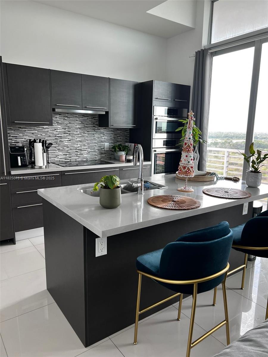 Modern Condo located in Midtown Doral, a vibrant community known for its convenient location, lifestyle amenities, and modern architecture. This beautifully maintained 1 bed, 1 bath residence on the last (8th) floor offers higher ceilings and all the comforts of home in a desirable urban settings. The bright and spacious open floor plan connects the living, dining and kitchen areas. Enjoy kitchen with high-end stainless steel appliances, quartz countertops, and ample cabinetry. Private balcony with panoramic views of Doral, ideal for enjoying Florida Sunsets. Midtown Doral offers new amenities including fitness center, Spa, Pilates room, event room, a pool (waiting for permit) and concierge service. You'll be steps away from dining, shopping and entertainment.