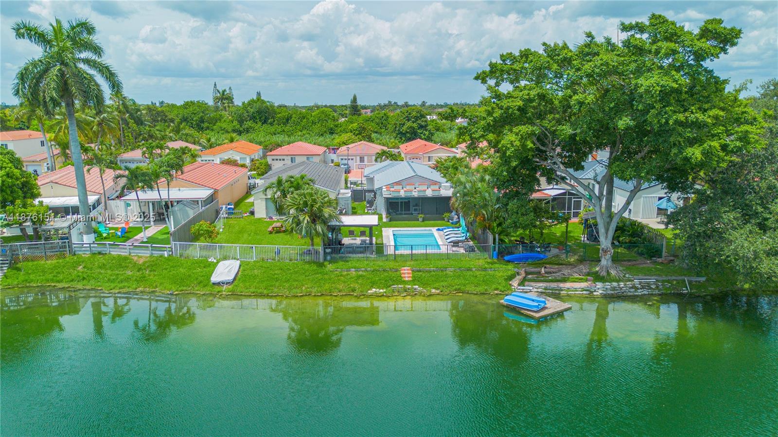 Welcome to your dream home! This stunning single-family home boasts 4 bedrooms, 2 bathrooms, and a 1 car garage. Enjoy breathtaking waterfront views from the kitchen, living room, and pool area. The in-ground pool is perfect for entertaining guests or simply relaxing on a hot summer day. The kitchen features granite counters, stainless steel appliances, and tile flooring. You can even swim in the lake right from your backyard! With natural gas for the water heater, stove, and dryer, you'll save on energy costs. The pool also has a heater for those chilly days. New impact doors and windows provide added security and peace of mind. This property has been completely remodeled this year, so you can move in and start enjoying your new home right away. Own a piece of paradise in Miami!