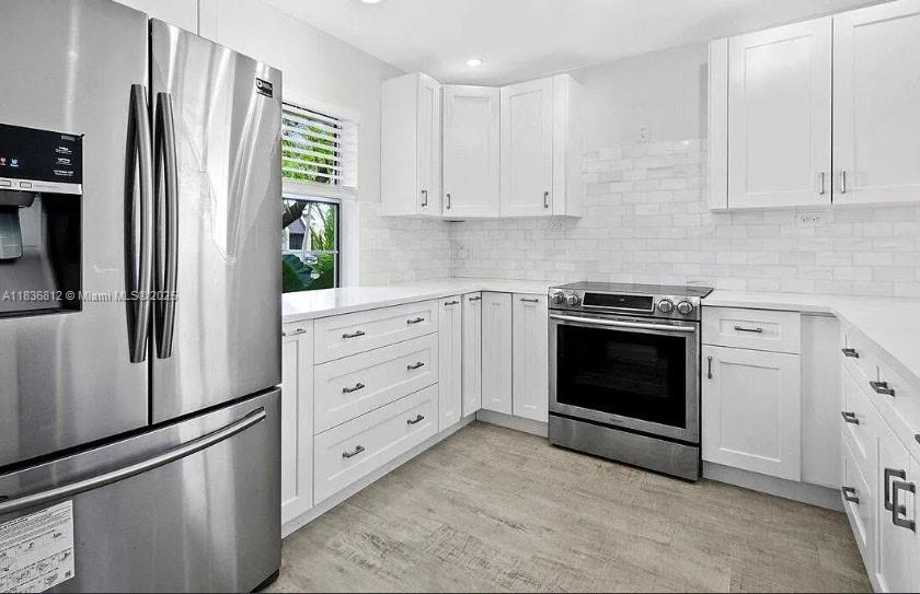 Bathed in golden light, this beautifully updated villa overlooks peaceful canal waters. Just a short stroll to the sparkling pool—yours to enjoy without the upkeep. Tucked at the end of a quiet lane with ample guest and RV parking, it sits in Golden Lakes Village, a vibrant 55+ community where laughter fills the clubhouse, trails wind through sun-dappled paths, and each day brings joyful gatherings. A full-time Lifestyle Director curates activities like live entertainment, weekly movies, dinners, aquatic aerobics, Zumba, lectures, and special interest clubs. Only 15 minutes to downtown West Palm Beach, the Kravis Center, shopping, and the airport.