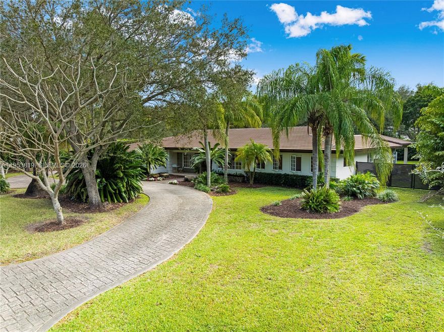 Set on a generous 30,709-sq-ft lot, this extensively updated Pinecrest home delivers exceptional space, comfort, and flexibility. A welcoming foyer opens to formal living and dining rooms, flowing into a newly renovated gourmet kitchen with eat-in area and family room, all filled with natural light from new impact windows and doors. The main bedroom wing offers four bedrooms, including the primary suite. A newly built east wing adds a second family room, large laundry room, fifth bedroom with walk-in closet, and full bath, ideal for guests, in-laws, or a private office with separate entrance. Recent upgrades include a new roof (2025), new A/C and ducts (2026), new pool heater/chiller (2025), and additional garage storage. Outdoors, enjoy a newly redesigned patio, pool, covered summer kitchen, and deep private backyard.