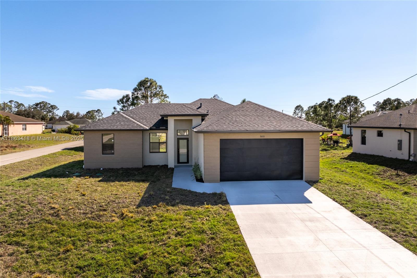 Stunning new contemporary construction home in Lehigh Acres, Florida, featuring 3 spacious bedrooms, 2 bathrooms. Thoughtfully designed for comfort and style, this home offer a functional layout with high-end finishes throughout. Inside, you'll find elegant porcelain flooring, sleek quartz countertops, and a chef-inspired kitchen complete with stainless steel appliances, modern fixtures, stylish cabinetry and kitchen under-cabinet lighting, making it perfect for both cooking and entertaining. It includes Premium upgrades as closet's carpentry in the laundry and master. Ideally situated on corner lot of over a quarter acre. Near shopping, dining, and essential amenities.