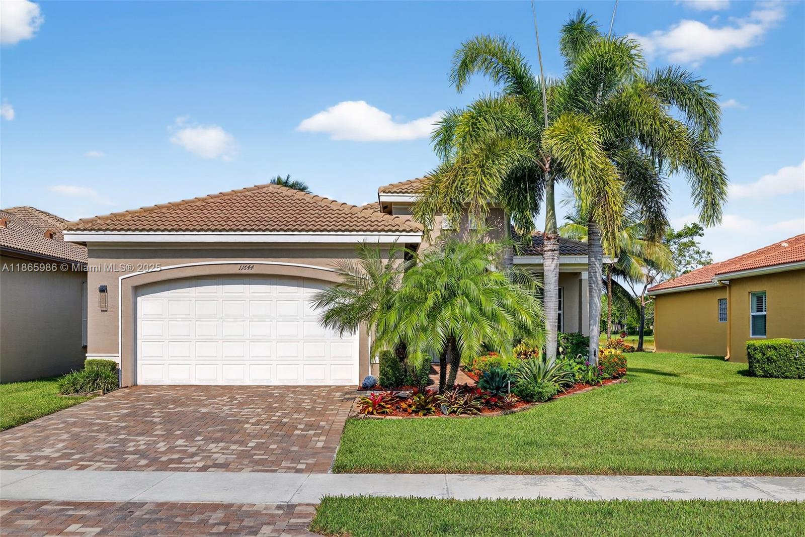 This Rebecca model on a long lakefront lot in Valencia Cove, a premier 55+ community, features lush landscaping, hurricane impact windows, wood-look tile floors, crown molding, recessed lighting, custom window treatments & designer closets. The kitchen has white cabinetry and a large breakfast bar; the formal dining room seats ten. The master suite includes a bay window sitting area, upgraded bath w/ quartz countertops. The den has custom tile flooring, and the garage features epoxy-finished floors & cabinetry and a built-in generator switching panel. The covered patio has an oversized "birdcage" with an electric retractable awning. Community amenities - clubhouse, ballroom, cafe, card room, fitness center, steam room, resort, lap and resistance pools, tennis ,pickleball, bocce and more.