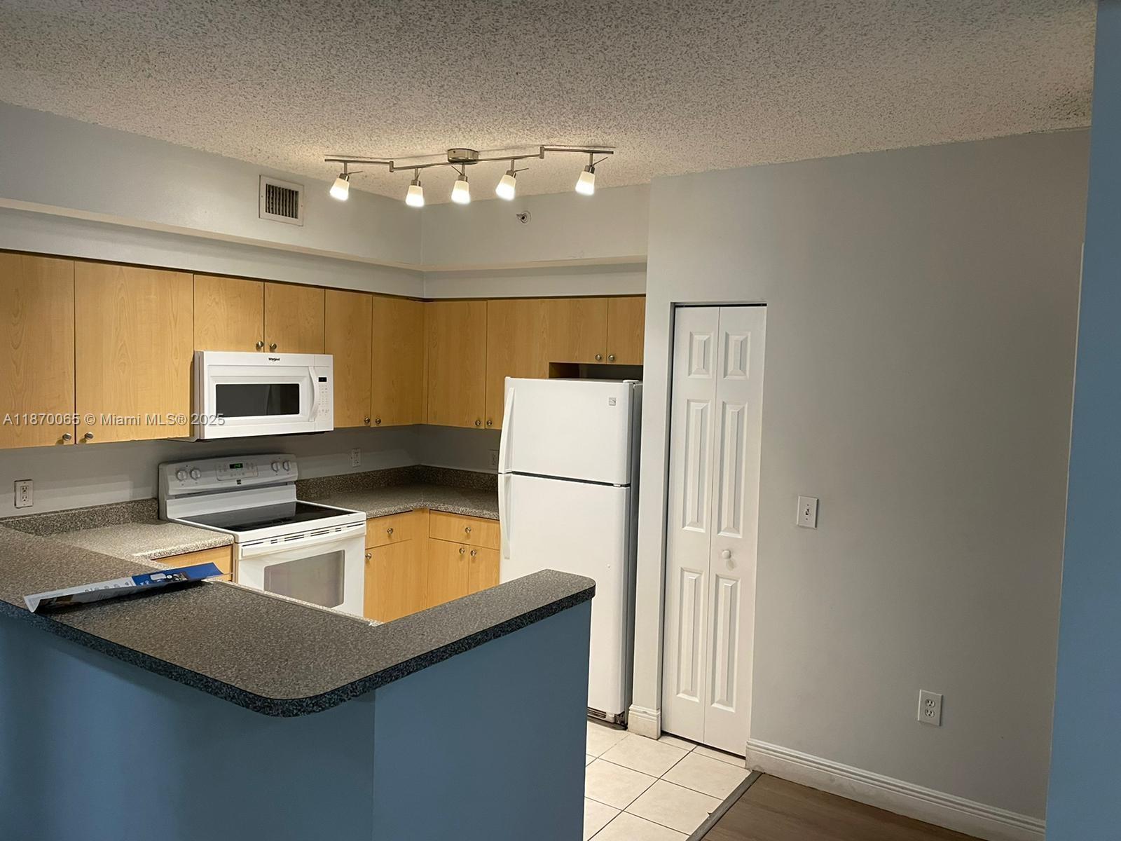 Great 2/2 unit located in the St. Andrews community of Tamarac. Unit features laminated floor throughout, split bedroom layout and is 2nd level with walk out balcony area. One of the bathrooms is updated. Full size washer & Dryer. Community features a resort style pool, clubhouse, gym, and tennis court. Rent INCLUDE: Water/Sewer, Garbage Removal. Close to the Schools an Parks.Unit will be delivered fully painted, professionally cleaned and move in ready. more pics coming soon.