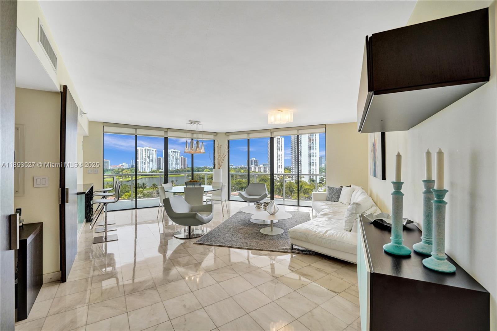 This beautifully furnished bright unit offers 3 BD + den/office/guest room & 3 full bath. It boasts a modern look,
tastefully decorated & fully renovated. Marble floors in living areas & bamboo floors in bedrooms. Access to balcony from all rooms to enjoy beautiful views of the pool, lake, golf course & Aventura skyline. An open-layout floor plan that joins multiple spaces promoting an airy ambiance. Open kitchen, white glossy cabinets, SS appliances, granite countertops & tiled backsplash. Ample closet space. Luxury living in The Hamptons; two pools, a private gourmet restaurant, Wi-Fi café, Movie Theater, state-of-the-art fitness center & spa, tennis & racquetball courts, party room & Kids playroom. Enjoy strolls in “the circle”. Available for annual rent, offered only furnished.