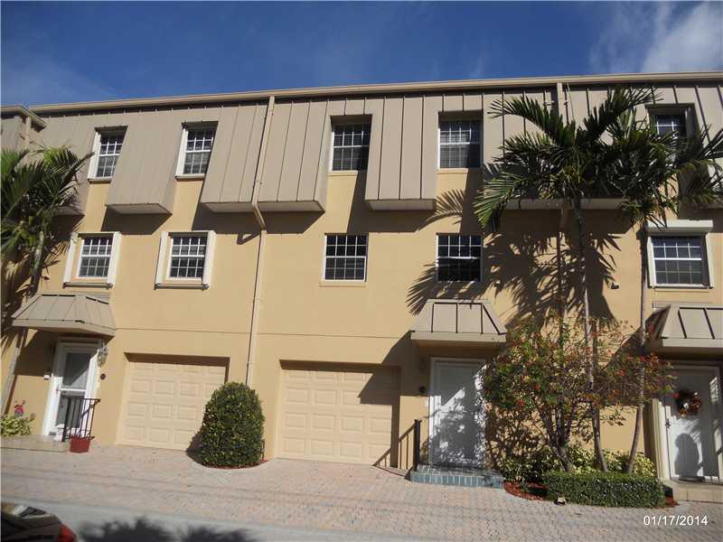 Secure tri-level townhouse within a manned gated community walking distance to the beach! This intimate community of only 18 townhomes are located on the intracoastal surrounding a lush tropical pool. The north facing patio is cool and peaceful. The impro vements include an elevator, garage, and nearly new kitchen with custom cabinets, and granite. Dark Wood floors gleam in the natural light, and the elegant spiral stairs saves space and makes access convenient. 2-Zone A/C, deeded beach rights.