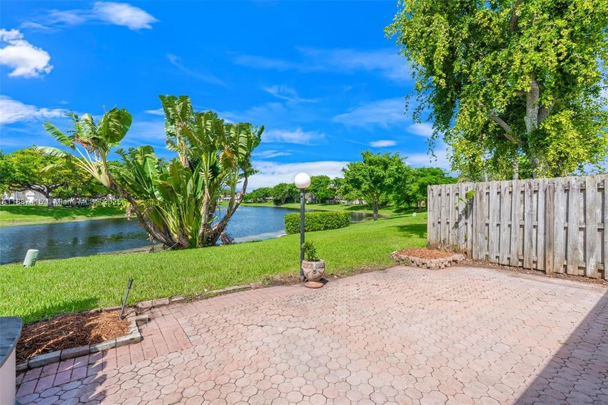 LAKE FRONT LIVING!! Enjoy this 2 bed/2 bath w/ fenced front yard in an ALL AGES, PET FRIENDLY community just minutes from I-95 & the Turnpike. Both bedrooms have en suite baths for comfort and privacy. The kitchen has white shaker cabinets, beautiful countertops, and stainless steel appliances, opening to the dining/living area so you're always part of the crowd. The pantry offers loads of space for food and storage. Vaulted ceilings give the living and dining room a spacious feel. Front yard is a fully fenced for your children or furry friends, and the back offers an amazing water view to enjoy on your screened lanai or paver patio. A large storage closet & laundry closet are also on the patio. AC 2017, HW heater 2019.  Roll down hurricane shutters.  Private parking in front of unit.