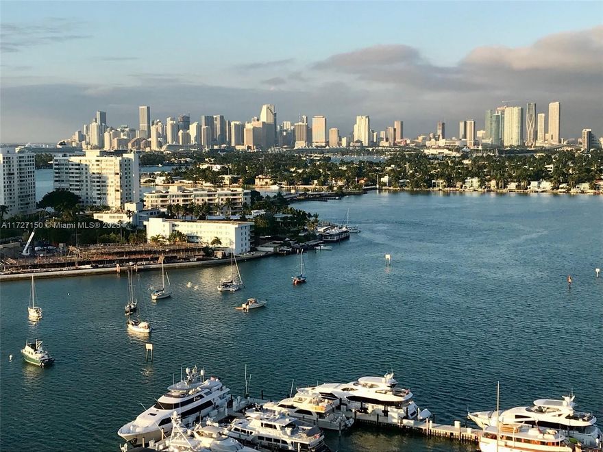 High floor SE corner 2 bedroom and 2 bathroom unit with 2 balconies in the highly desired, walkable Sunset Harbour neighborhood. The views make this unit a must see - incredible sunrises over the ocean AND sunsets over the bay and downtown. Recently updated including new impact windows and doors. Tons of natural light. Full-service building with 7th floor bayside pool, hot tub, gym, plus access to the oversized Sunset Harbour Yacht Club pool - perfect for swimming laps. You won't need your car, but the unit comes with 2 parking spaces. Sunset Harbour North is completing a major renovation (ASSESSMENTS PAID BY SELLER!) of bayside pool deck, exteriors, gym (done!) and elevators.  Maurice Gibb Park reopens in April. A savvy buyer comes into an essentially like new building in a prime location