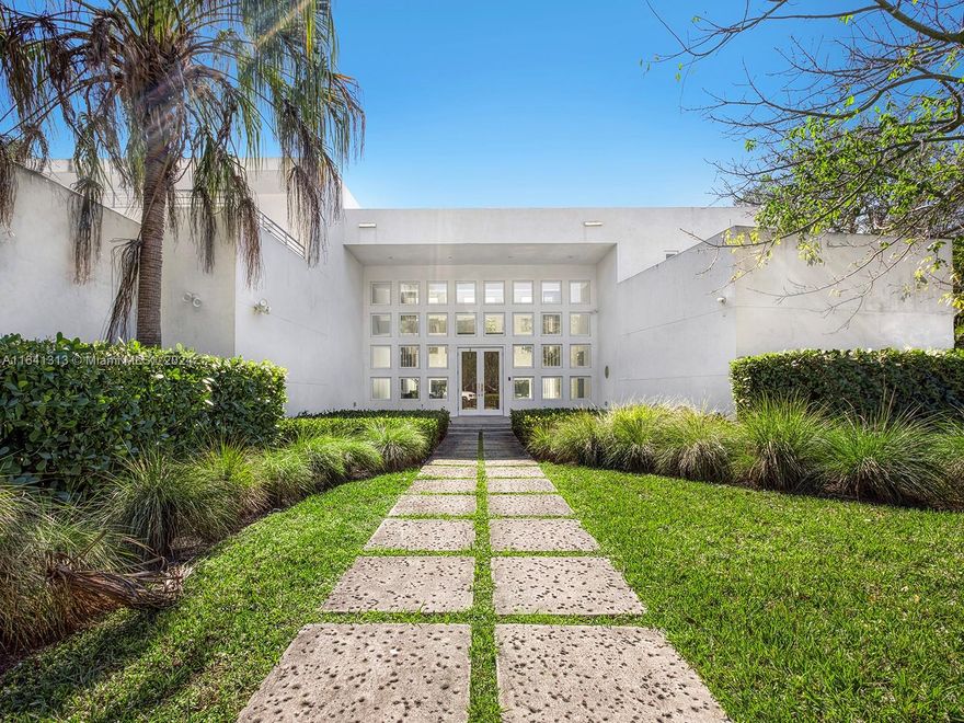 Welcome to this exquisite 6-bed, 6-bath residence in prestigious Pinecrest. This all-concrete, French limestone- clad home spans 6,508 sq ft on a builder's acre, seamlessly combining luxury and sustainability. Opulent features include double-height ceilings, Italian oversized tiles, and hardwood floors. The gourmet kitchen, custom bar, and loft-style family room are perfect for entertaining. Outside, a 40-foot infinity-edge pool awaits. With a 3-car garage, this home offers convenience. Situated in a security-staffed, guard-gated community, it provides peace of mind. Showcased in Architectural Digest and Florida Design, with accolades like the AIA COTE Award and US Green Building Council Home of the Year, this is Pinecrest's premier LEED Gold Home