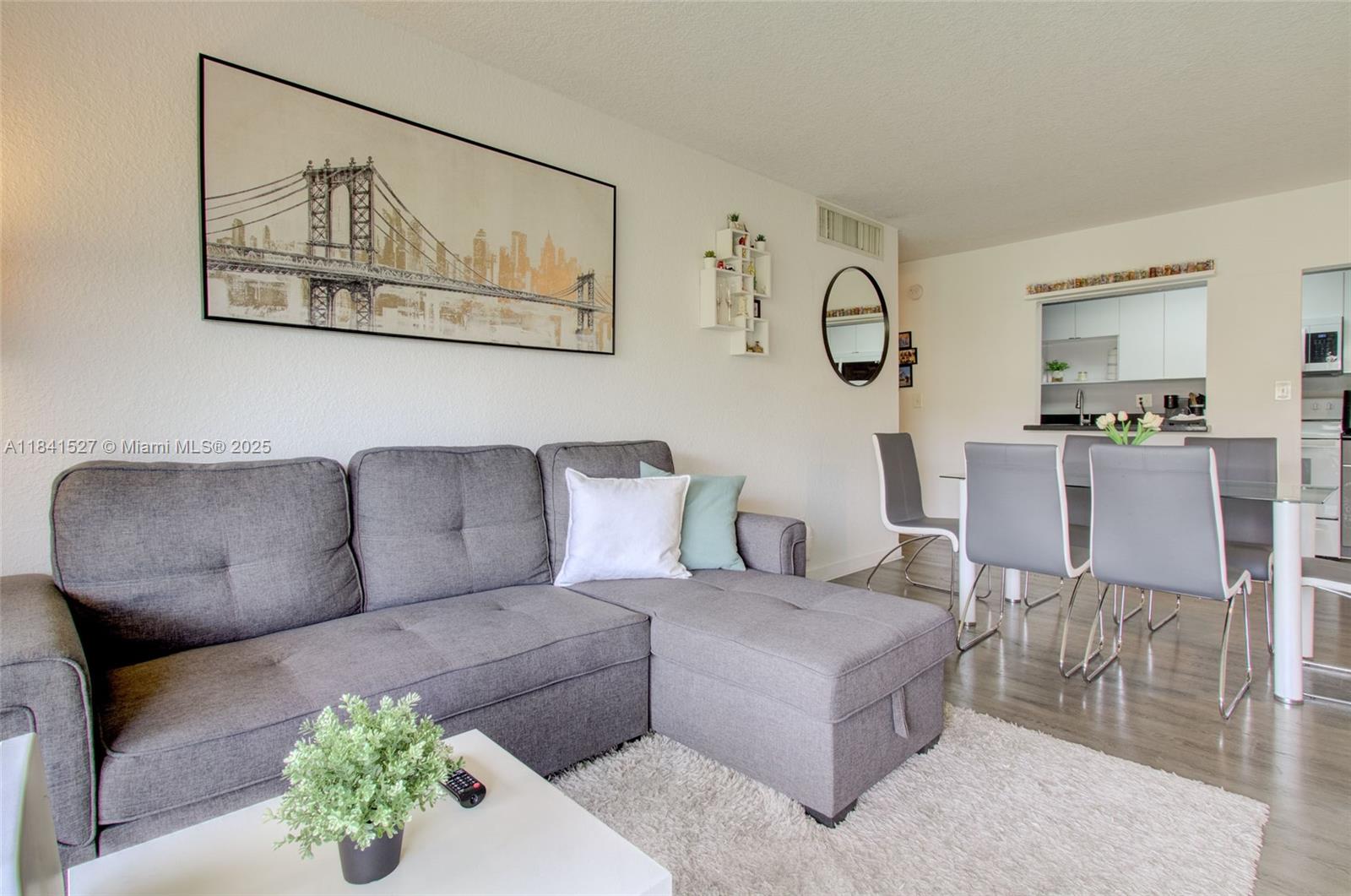 Don't miss this opportunity to live in a stunning second-floor apartment located in the desirable gated community of DORAL GARDENS in the heart of Doral. This bright and modern 2-bedroom, 2-bathroom unit features a remodeled kitchen with sleek finishes and ample cabinet space and a pantry closet, laminate wood floors throughout for a clean, contemporary look, two remodeled bathrooms, a private balcony perfect for relaxing or entertaining and two parking spaces. The floor plan design offers privacy and comfort. Enjoy the convenience of living close to top-rated schools, shopping, dining, parks, and major highways. This is the perfect home for anyone looking for comfort, style, and a prime location all in one.