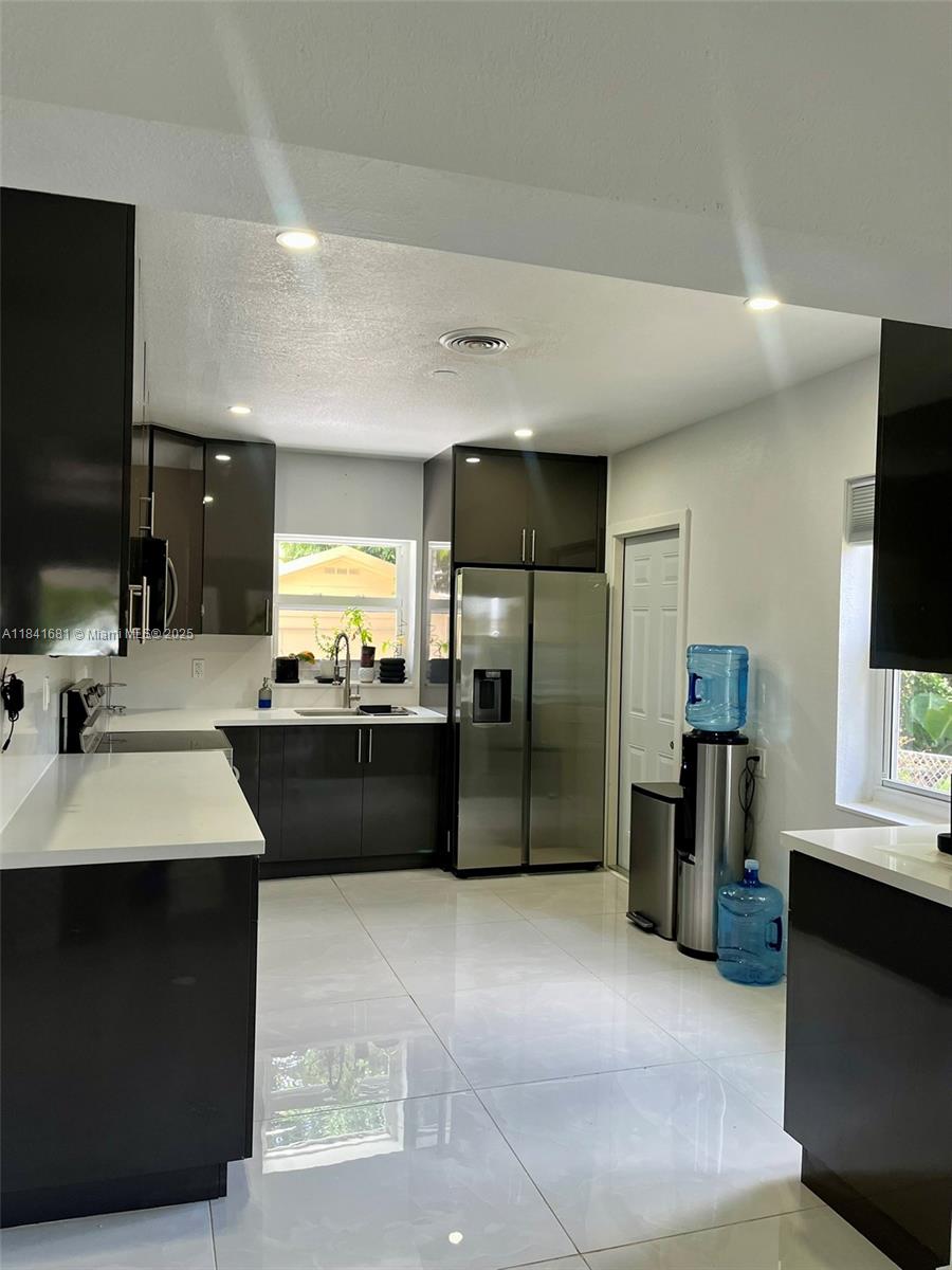Discover your perfect North Miami retreat! Step into this newly remodeled, fully furnished 3-bedroom, 2-bath home—thoughtfully designed for families or groups of up to 6. Whether you’re planning a fun getaway or a longer stay, you’ll love the modern comforts, with utilities and high-speed Wi-Fi included for short-term leases. Take advantage of discounted rates for yearly rentals! Please note: local taxes apply to stays under 6 months, and a $250 non-refundable cleaning fee ensures everything is spotless for your arrival. Don’t miss out on this bright, inviting space—your hassle-free Miami home awaits!