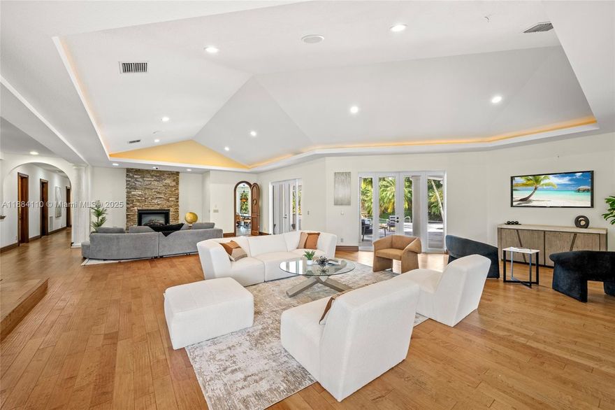 Set on 2 plus acres in Rolling Oaks, this custom 5,965-SF estate blends volume, light, and indoor-outdoor living. Built in 2007 (flat-tile roof 2008), the 4-bed/5.5-bath plan features impact glass/doors, soaring ceilings, and an open layout. Chef’s kitchen with island, premium appliances (gas range, wall oven, separate freezer), and formal/casual dining. The main-level primary suite offers a sitting area, dual closets, and a spa bath with a separate tub/shower. Flexible spaces include an office, family room, media/loft, in-law quarters, and large laundry. Outdoors: 40'×25' pool with whirlpool, summer kitchen with built-in grill, expansive patio, fruit trees, fenced grounds, circular drive, and 3-car garage. Well water; septic.