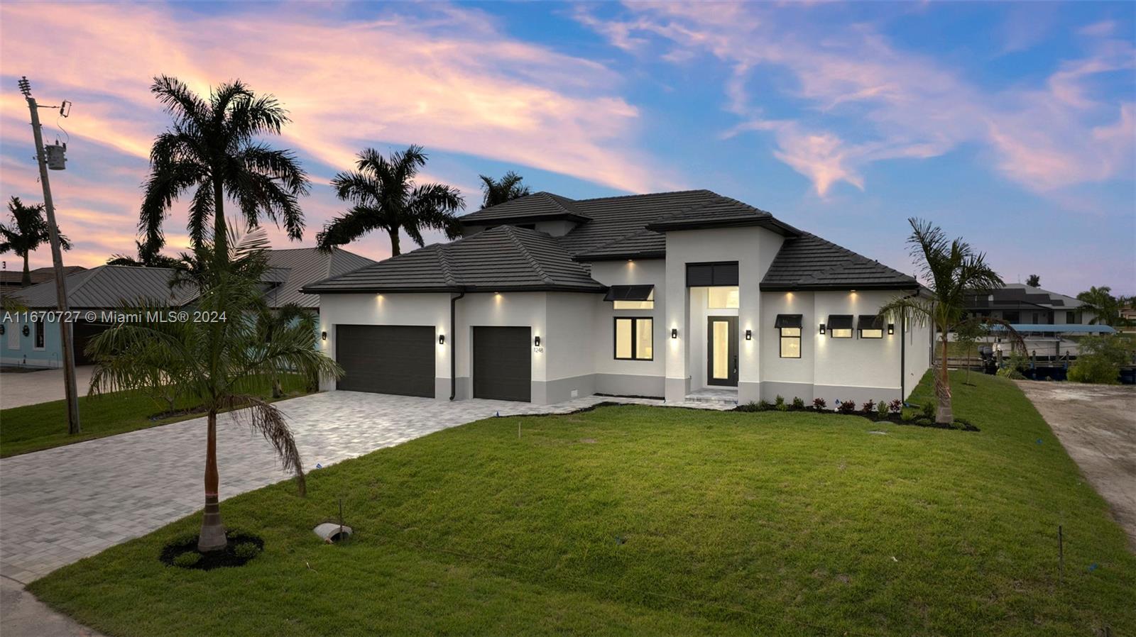 Welcome to your waterfront dreamscape in beautiful Cape Coral! The "Grand Cayman 2 Story" boasts 4 spacious bedrooms, 4 luxurious bathrooms, and a 3-car garage. 90-degree pocketing sliding glass doors open to the spacious paved lanai inground pool/spa, a great space for relaxing, entertaining guests and with Western exposure enjoying our beautiful Southwest Florida sunsets. Upstairs you will find an additional bedroom, full bath and bonus room with a balcony to take in the panoramic views. With plenty of space for everyone, whether it be for families, a vacation home or rental, or for those who love to entertain. This NEW construction home is the ultimate blend of luxury and comfort .Don't miss out on the opportunity to make this stunning home yours!