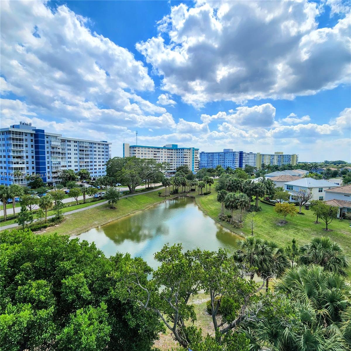 Limitless 270 degree views of lagoon, lush trees, sky & Hard Rock. Sprawling, sun-filled 3/2.5 corner unit. Relax on 2 large balconies. Tons of windows, ample closet space including 4 walk-ins. Full size washer/dryer in unit, new in 2023. 2 close parking spaces plus guest spots, extra huge storage space on 2nd floor. Gracious double-door entry welcomes you to foyer & huge great room, big bedrooms. Building passed 40-year recertification in 2021 & has newer roof. Amenities: pool, hot tub, shuffleboard, walking path near lagoon, gazebo, bike storage, BBQ, tennis… Maintenance includes 24/7 security in lobby, cable, water, pest control, etc. As-Is, inspections welcome. Minutes from Hollywood Beach/Broadwalk, Hard Rock Hotel/Casino, Brightline station, shopping, dining, entertainment, airport.