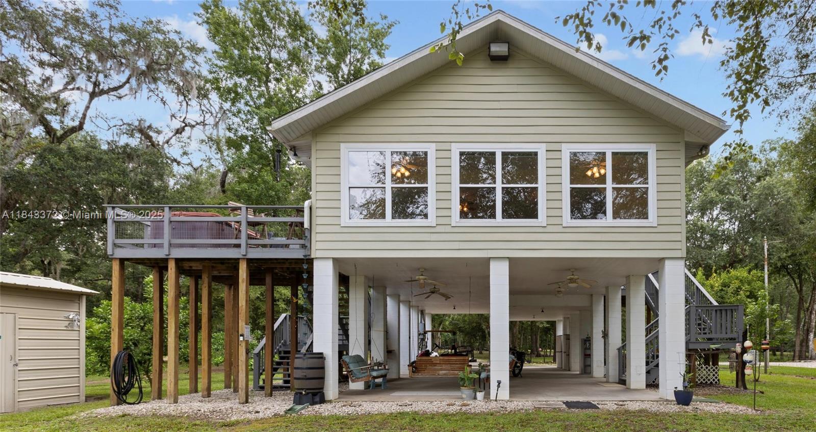 A PIECE OF HEAVEN ON THE SUWANNEE RIVER! Charming waterfront 2BR/2BA stilt home on 1.42-acre lot, with butterfly gardens & citrus trees. 2 large decks great for grilling out, entertaining, or relaxing in your new Hot Tub! Under the home, space for vehicles, golf carts, bicycles, and RV 30 and 50amp breakers! New well pump and pressure tank with triple water treatment system, plus ice maker, and a 46” lawnmower with shed. An elevator/pulley for easy groceries access to the 2nd floor. A boat house dock making fishing and boating easy. Make riverfront lifestyle your next home, a seasonal or summer getaway, or lucrative income producing investment. With abundant space for unforgettable gatherings, and ample amenities, this home offers something for everyone. Make this Summer one to remember!