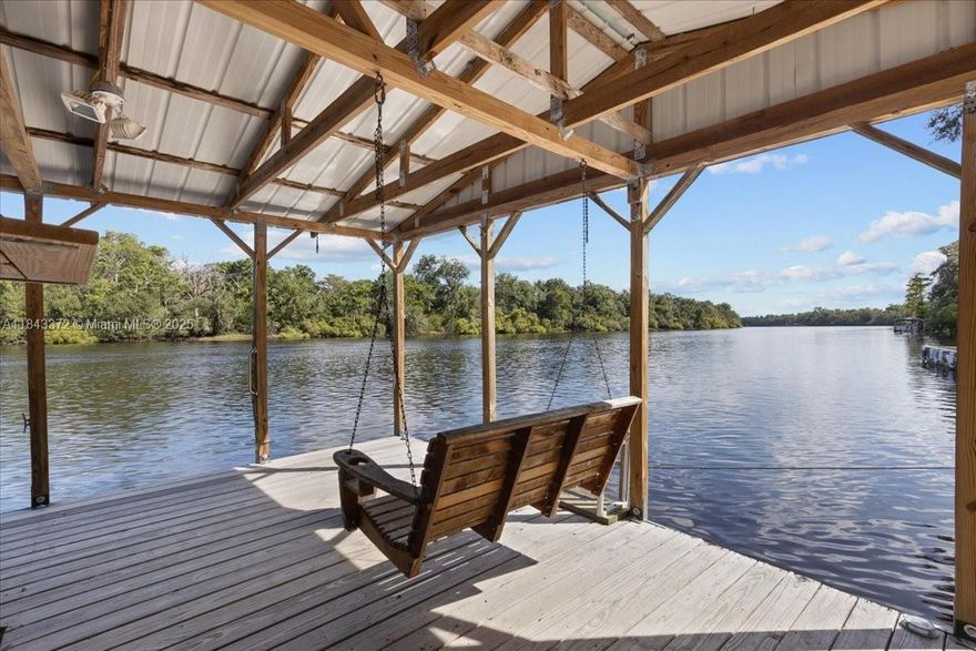 Escape to the historic Suwannee River and experience the ultimate “Old Florida” waterfront lifestyle in this stunning stilt-home perched high above the riverbanks on a sprawling 1.42 wooded acre lot offering unmatched peace and quiet. A bird’s eye view of Florida’s most iconic waterway and pristine river systems in the nation. 
Whether you are launching a boat, jet ski or kayak from your private covered boathouse, fishing for bass or simply soaking in the serene sounds of nature, this home provides a tranquil retreat where time seems to move a little slower. Live the perfect blend of elevation, privacy and adventure! The property is strategically located near world-class springs and scenic biking/walking trails. Don’t just visit the river - own a piece of its history. Contact Listing Agent for a tour today!