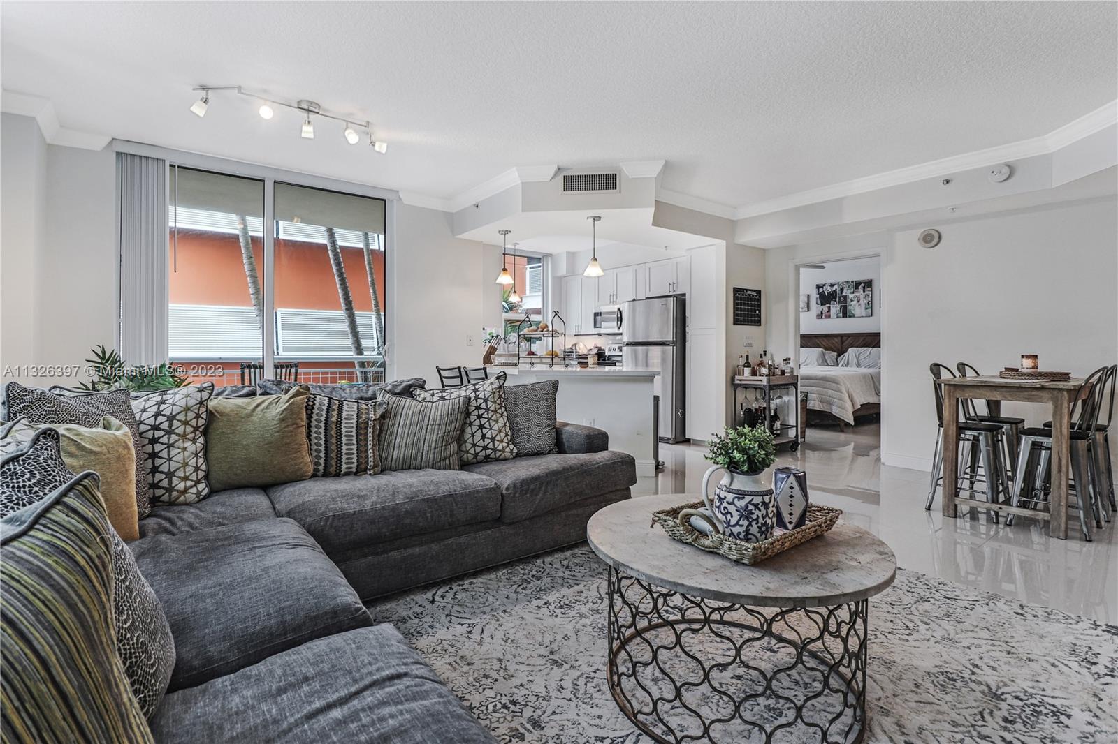 Coveted Corner Unit in Cite w/2 parking spaces in Edgewater! Open kitchen boasts ample cabinetry, granite counters, & SS appliances. The generous split floor plan is complimented w/light porcelain tiles thru-out; large impact glass windows & doors afford natural sunlight. Custom built office in one of the bedrooms with Murphy bed is perfect for a home office/guest bedroom. All BRs are spacious w/large closets & in unit laundry room! Cite offers heated beach entry pool, spa, Techno gym, concierge, 24 hr security & onsite Management. Across from Margaret Pace Waterfront Park, w/tennis, volleyball basketball, children's play area & dog park! Stroll to restaurants, theater, Publix or jog across the Venetian Causeway. Cite is LARGE pet friendly.