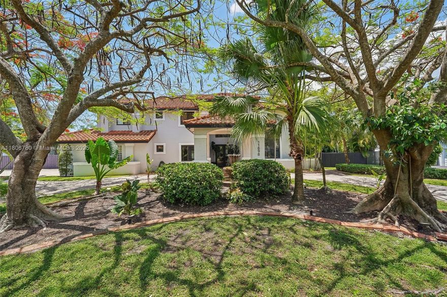 Magnificent two-story estate with 5-beds, 5-bathroom on a 0.51-acre lot. Features include a 20ft+ height foyer with natural light, soaring ceilings, impact windows and doors, and elegant details like a dramatic staircase and coffered ceilings. The gourmet kitchen boasts wood cabinetry, granite countertops, Viking stainless steel appliances, and a large island. Flexible dining areas, a bar, and multiple living rooms offer ideal entertaining spaces. The luxurious primary bedroom upstairs includes a spa-like en-suite bath with a soaking tub and shower. Outside, enjoy resort-style living with a sparkling pool, covered patio, and beautifully landscaped grounds—perfect for entertaining or relaxing in your own private oasis. Guarded gate and 24 hrs security.