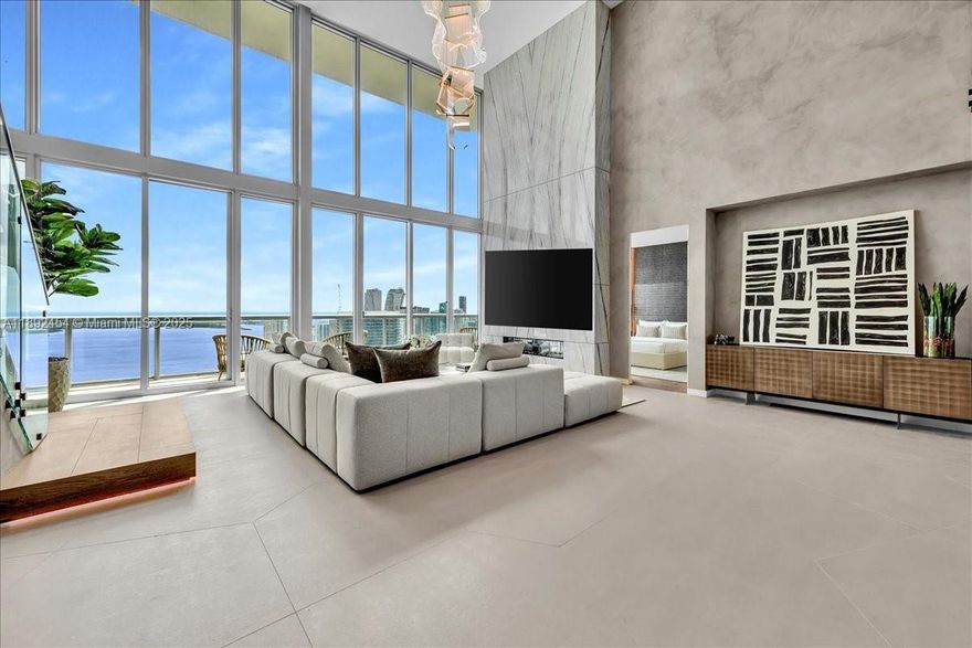 A TRUE MASTERPIECE! Fully Renovated 2 Story Penthouse with over $1.3M in upgrades! No detail overlooked showcasing bespoke finishes & dramatic 20 foot floor-to-ceiling windows framing direct east views of the ocean & Intracoastal waters. Features include custom imported Italian flooring, Miele & Thermador appliances, wine cooler/bar, marble accent wall,  Lutron dimmable lighting, Sonos sound system, & designer walk-in closets. Glide up your sleek staircase to your impressive marble walls, smart-glass privacy tint, freestanding tub, steamer shower, & Toto luxury toilet. Marina Blue is conveniently located steps from Kaseya Miami Heat Stadium, Bayfront Park, Bayside, One World Center, Arts district, Brickell, & endless high end shopping & restaurants. Monthly HOA being reduced to $2775 in 2026! Absolutely unheard of!