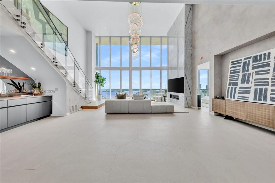 A TRUE MASTERPIECE! Fully Renovated No Expense Spared 2 Story Upper Level Penthouse! No detail overlooked showcasing bespoke finishes and dramatic 20 foot floor-to-ceiling windows framing direct east views of the ocean and Intracoastal waters. Features include custom imported Italian flooring, Miele & Thermador appliances, wine cooler and bar, marble accent wall,  Lutron dimmable lighting, Sonos surround sound system, and designer walk-in closets. Glide up your sleek staircase to your primary suite with impressive with marble walls, smart-glass privacy tint, freestanding tub, steamer shower, and Toto luxury toilet. Marina Blue Residences is conveniently located near the Miami One World Center, Kaseya Center, Bayfront Park, Theatre District, Brickell & Miami Beach.  A Brand New Masterpiece!