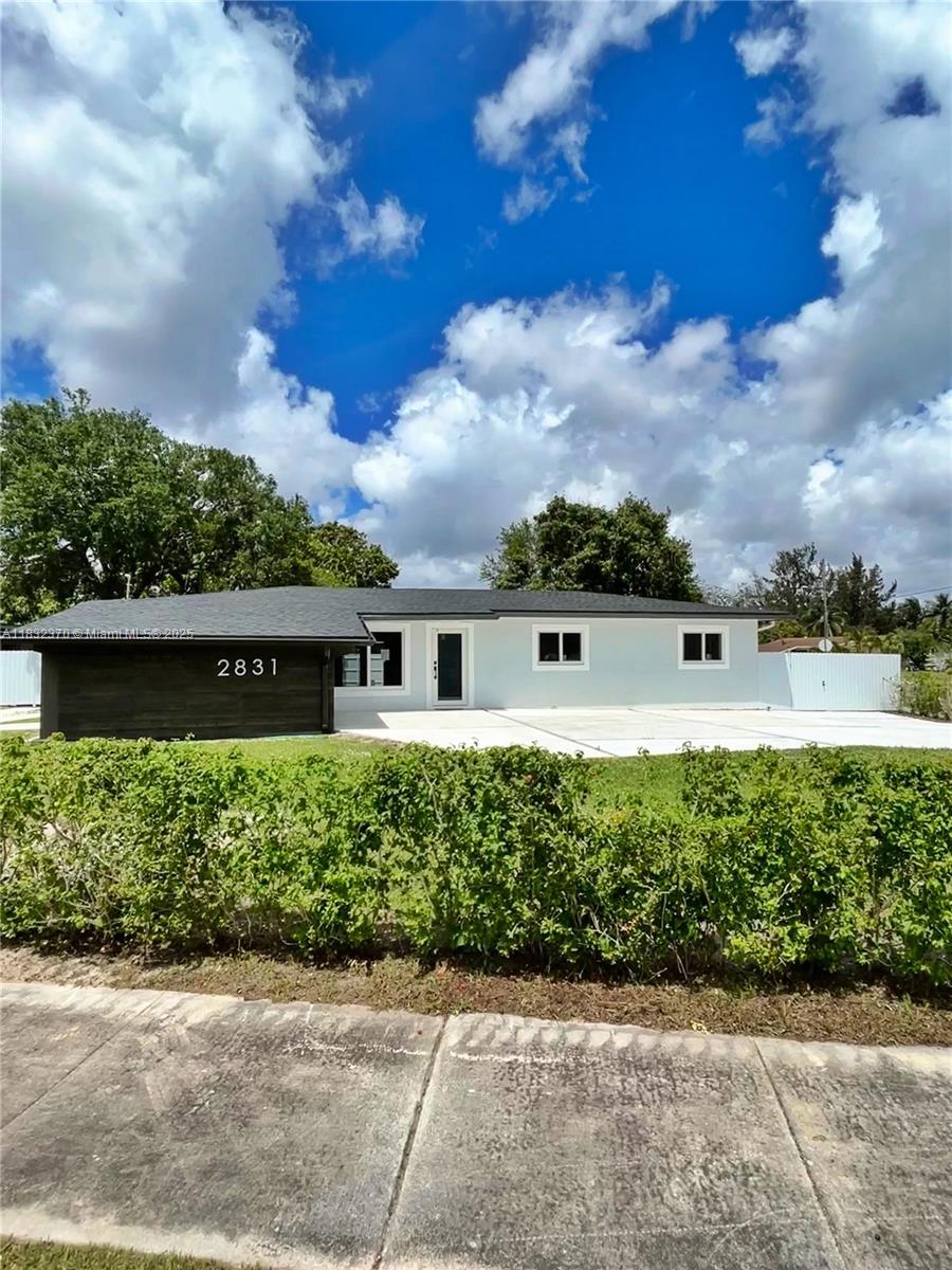 Stunning single-family home situated on a spacious corner lot, offering 4 bedrooms and 2 bathrooms of beautifully remodeled living space, bigger than tax records. This home features a brand-new roof, elegant porcelain floors, and a modern open-concept kitchen with Quartz countertops and stainless-steel appliances. The property is surrounded by new impact windows and doors, allowing an abundance of natural light to fill every room.