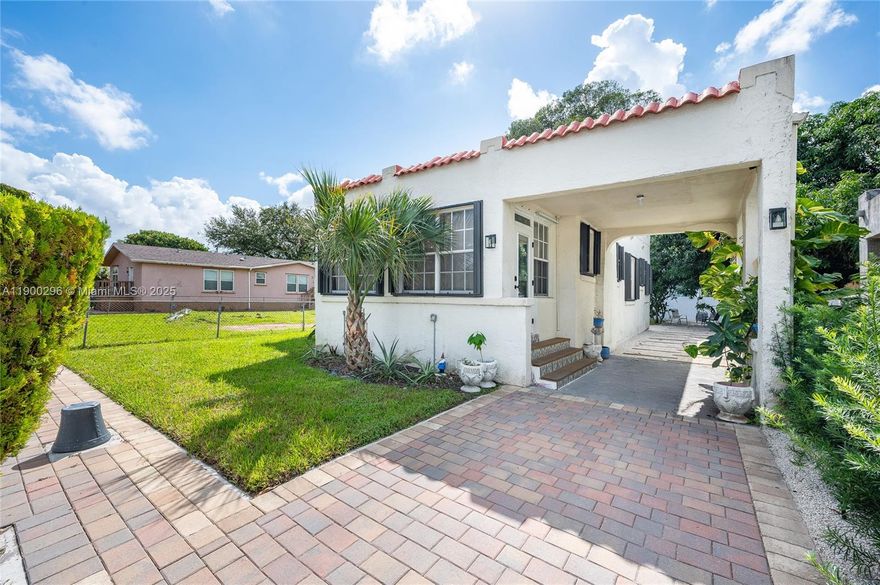 Miami's history lovingly and meticulously reimagined. This beautifully restored 1936 Spanish home blends timeless charm with modern comfort across 1,316 sq ft on a gated 4,800 sq ft lot. Sun-filled living with arched entries and a statement fireplace leads to a stunning kitchen with white cabinetry, bamboo counters, and blue Spanish tile backsplash. Two serene bedrooms and two remodeled baths feature impact entry door, new floors, and stylish finishes. Enjoy central A/C, laundry area, gated drive, covered carport, Tesla/EV charger-ready, and a tropical yard with mango tree and 15×10 shed. Minutes from Wynwood, Design District, and Miami Beach—this home delivers character, comfort, and location. Turnkey, move-in ready, Yale smart lock & 65" Samsung TV included.