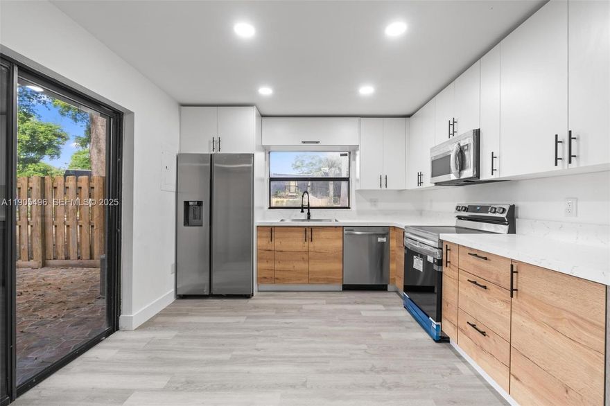 Completely remodeled 2-bed, 2.5-bath townhome located in the desirable community of The Hammocks. This modern residence features an open-concept layout with abundant natural light and brand-new waterproof flooring. The kitchen has been beautifully redesigned with two-tone cabinetry, quartz countertops, and stainless-steel appliances. Spacious living areas flow into a private tiled courtyard, ideal for entertaining. Bedrooms upstairs each include balcony access and updated bathrooms. Enjoy resort-style amenities including pools, gym, and walking trails. Conveniently located near top schools, shopping, and major highways. Move-in ready!