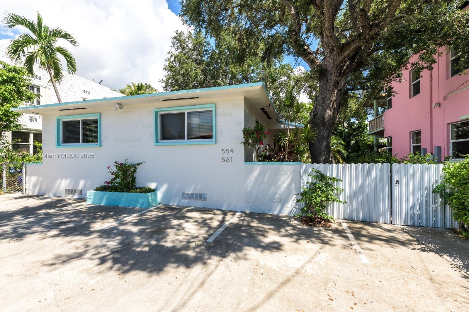 Charming 2-bed, 2-bath home honors 1950s MiMo design with Art Deco, modernism, and tropical flair. Enjoy modern comforts like central A/C, impact windows/doors, washer/dryer, and two reserved parking spots. Enter through a lush garden to a cozy front porch. Inside features wood floors, retro kitchen with gas stove, oven, and marble countertop. Bedrooms are bright with large closets; bathrooms showcase vintage charm. Relax in the beautiful, lush backyard. Walk to local favorites like Starbucks, Panther Coffee, Sweat 440, Caracas Bakery, Chip City, El Bagel, Oakberry AçaÃ, Ceviche by Divino & Luna Pasta.