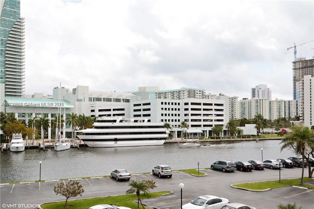 Discover this stunning condominium unit in Hallandale Beach, ideally situated in the vibrant Three Islands Blvd area. Enjoy the spacious and well-designed floor plan spanning nearly 1,100 square feet, featuring 1 bedroom plus a den (used as a second bedroom) and 1.5 baths. This unit boasts tile flooring throughout, an upgraded open kitchen, and a walk-in closet for ample storage. Located just minutes from pristine beaches, the Gulfstream racecourse and casino, Walmart, Aventura Mall, and a variety of dining options, this home offers both comfort and accessibility.