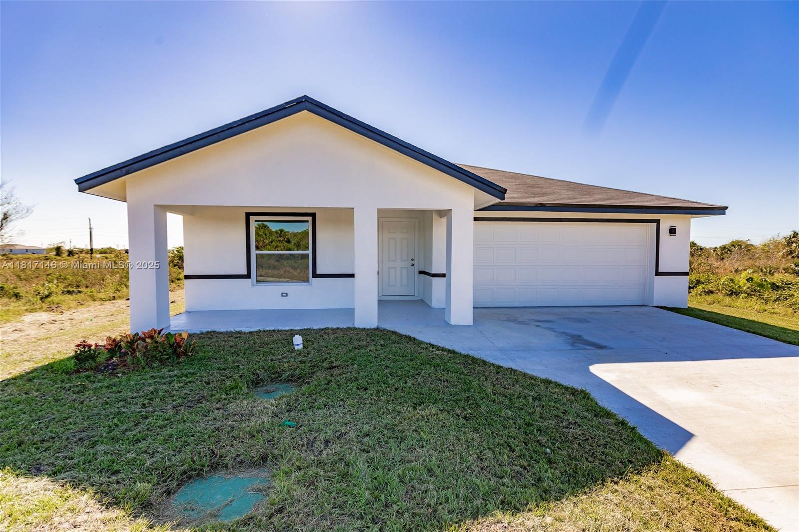 New construction in Port Labelle! Seller contributes $5k! This modern 3BR/2BA 2 car garage home offers 1798 Sqft of living space. Features include impact windows/doors, LED lighting, tankless water heater, hardwood cabinets and modern tile floors throughout. Open floor plan with split bedroom plan, walk-in closet in the master with his/her master bath sinks. Located in growing new development 1 hour and 45 mins from Miami- perfect for those looking to get away from big city and get comfort, quality and value without having to be far from loved ones. Hablo espanol! Call me for your showing appointment today!