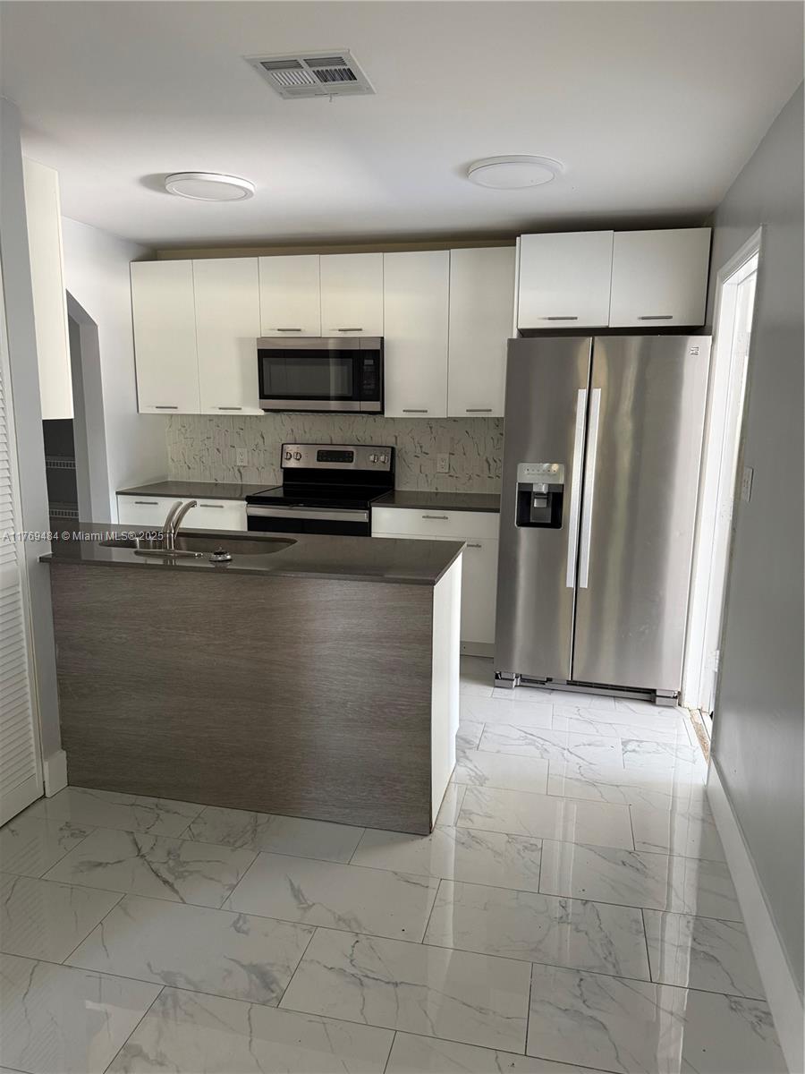 Freshly painted. End unit townhouse. Tile floor. Master downstairs, two bedrooms upstairs. Large closets. 2 car garage and 2 car parking driveway. Screened in patio.