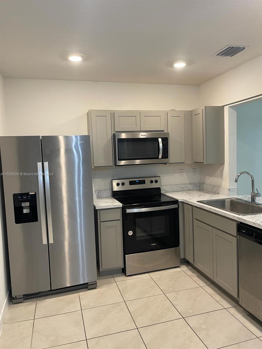 Welcome to your modern 3-bedroom, 3-bathroom townhouse nestled in Keys Pointe, built in 2022. Positioned just moments from the Florida City Outlet Mall and the Florida Turnpike, this residence boasts two master bedrooms on the upper level complemented by ample closet space, while a convenient third ground-floor bedroom. Inside, discover the convenience of an in-unit washer and dryer, alongside a covered fenced-in patio, ideal for relaxation and outdoor gatherings. With two dedicated parking spaces. Enjoy community perks like a clubhouse, pool, gym, party room, basketball court, and playground. New Publix is currently being constructed just minutes away, adding to the area's convenience and appeal.