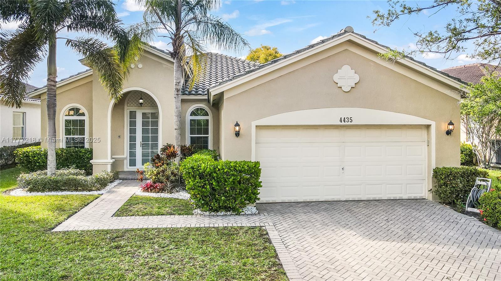 This stunning 4-bedroom, 2-bathroom waterfront home in the Isles at Weston blends sophistication and modern comfort. The open design is highlighted by exceptional upgrades throughout including a gourmet kitchen with high-end cabinets, stainless steel appliances, quartz countertops and built-ins. The spacious living areas are filled with natural light and custom impact sliding doors lead to your private paved patio. The split floor plan features volume ceilings, tile flooring in the living areas and real wood floors in bedrooms. The backyard is ideal for entertaining guests while enjoying the stunning lake views in a peaceful setting. All windows and doors are hurricane impact. HOA offers resort style amenities. Conveniently located near shopping, top-rated schools and major highways.