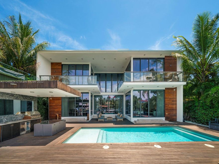 This exquisite contemporary residence, Designed by well-known Cheoff Levy Fishman, was designed to take advantage of its spectacular setting, with the Biscayne Waterway, allowing easy bay access, in the rear, and the Miami Beach Golf Club across the street. Designed as a home for entertaining, indoor and outdoor amenities abound, such as the living room with its 28 foot ceilings, the large waterfront dining room, the chef’s kitchen with Wolf and Subzero appliances and rich marble countertops, the family room in its own pavilion, and the waterfront pool with baja shelf and adjacent summer kitchen, set within a huge ipe wood deck. Upstairs, a large catwalk loft opens to a spectacular master suite with two very large terraces, two dressing rooms, and two water closets.