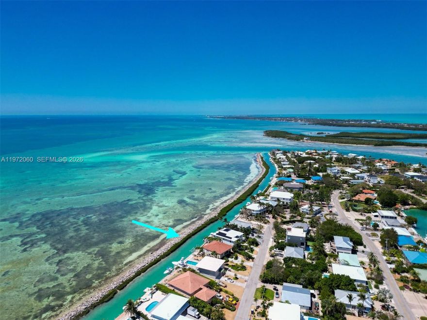 Motivated Seller...Call now to buy your perfect Dream home on the Oceanfront in beautiful Duck Key. Welcome to your dream coastal retreat on Duck Key, where BREATHTAKING COASTLINE VIEWS and refined island living exist in perfect harmony. This beautifully curated DESIGNER RESIDENCE is a three-bedroom, three-bath oceanfront concrete home by D'Asign Source, blending timeless elegance with modern comfort through soft earth tones, quality finishes, and sweeping panoramic views of the turquoise waters beyond. Inside, a spacious chef's kitchen anchors the home--ideal for entertaining--while a thoughtfully designed split floor plan offers privacy and flow. Two guest bedrooms enjoy direct ocean views, and the expansive primary suite is a serene sanctuary featuring a luxurious en-suite bath with designer tile, dual vanities, custom cabinetry, and a built-in makeup station. Step outside into your private waterfront oasis. A custom oceanfront pool deck and generous covered patio create the perfect setting for relaxation after a day on the water. A 25,000 POUND BOAT LIFT and seawall provide effortless access to the open ocean with no fixed bridges, making this an exceptional location for boating, paddleboarding, and kayaking directly from your dock. Additional features include a screened-in balcony with electric shutters, two large storage rooms, an L-shaped two-car garage, ample outdoor parking, and a wide driveway.