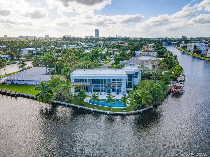 Polished modern two-story residence located in the gated community of Golden Isles. This residence sits on a secluded point lot with a beautiful infinity edge pool overlooking the intracoastal. 270 feet of water frontage with space for yachts on both sides. Open floor plan with natural lighting encompasses this spacious property with immaculate views throughout the interior. Floor to ceiling impact windows, marble floors, and a separate staffs quarter. Brand new custom gym and private gated driveway.