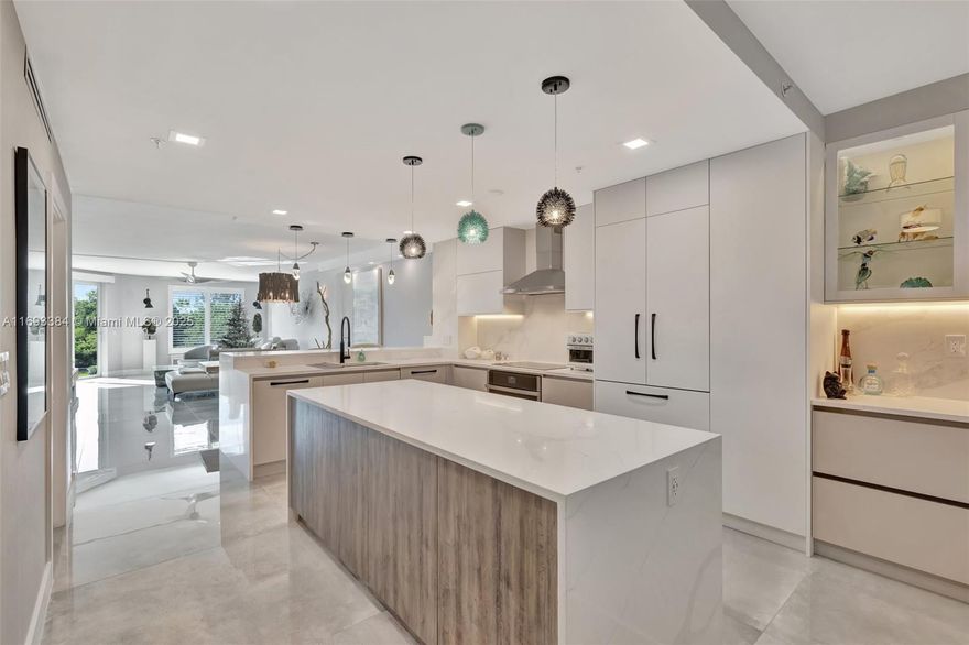 Discover luxury waterfront living in this exquisitely remodeled 2-bed, 2-bath first-floor residence with stunning views of the Intracoastal, canal, and nature preserve. Private first-floor haven features open concept design, premium finishes, chef’s kitchen with Dacor appliances, custom cabinetry, and a coffee/wine bar w/office area. Spacious primary suite boasts custom closets, dual vanities and a spa-like shower. Enjoy a private patio with grass & direct access to seawall & docks. The Pointe offers resort-style amenities, including a pool & Jacuzzi on the ICW w/expansive outdoor area, gym and a beautiful party room. Fully funded reserves and recent inspections provide peace of mind. Bulletproof building w/low fees. Minutes from beaches, dining and FTL Airport. Designer Furniture Negot.