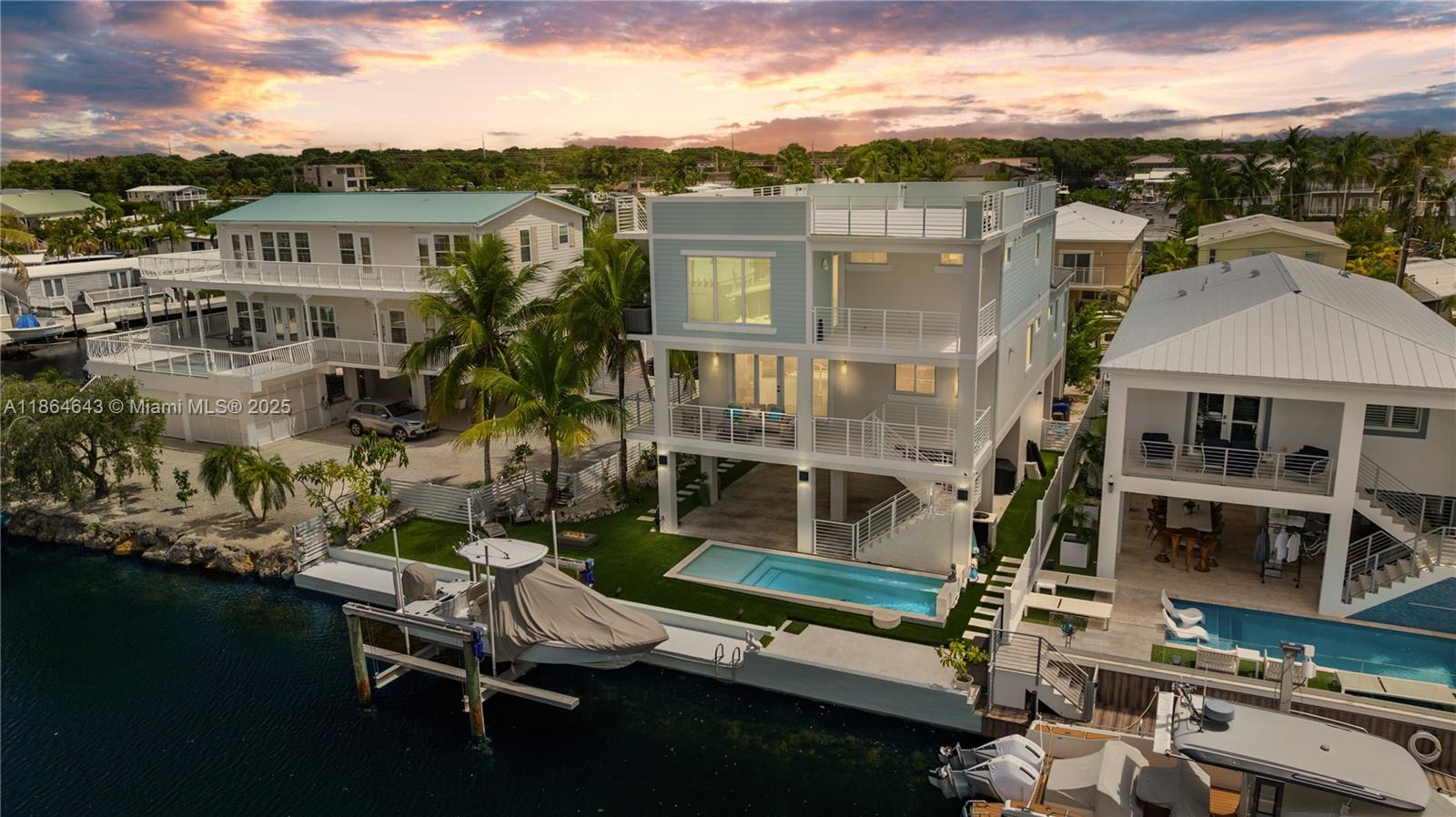2023 custom-built residence in Cross Key Waterways. 69-foot dock,16,000 lb. 4-pole boat lift. Easy Ocean access through nearby Adams Cut. 5,441 sq. ft. lot, 3,362 sq. ft., 4 bedrooms, 4 baths. Impact windows & doors, concrete roof. 240 sq. ft. saltwater pool with beach shelf, heater and chiller. 299 sq. ft. of storage, and (2) 50-amp outlets for your electric vehicle and camper on ground level. Kitchen with Viking appliances, custom cabinetry, pantry, and island—flow into living area. 2 bedrooms and baths complete the 2nd floor.
Primary suite with spa-style steam shower, generous closet, wet bar, and private balcony overlook the Bay. Additional bedroom, bath, and spacious laundry room are also located on the 3rd floor.
Two staircases and an elevator. 1,562 sq. ft. rooftop deck.