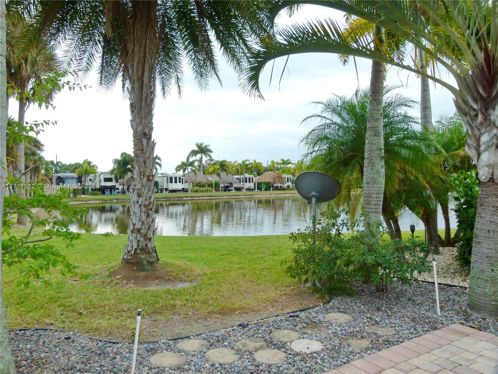 Silver Palms 5-Star Resort - Premium Corner Lot with Stunning Features Welcome to a meticulously manicured corner lot in the renowned Silver Palms 5-Star Resort. This exceptional property boasts a charming Tiki Hut, complete with patio furniture, making it the perfect retreat for relaxation or entertaining. Enjoy serene, calming views of the lake—a sight that lifts the spirits and soothes the soul. The resort itself offers an unparalleled lifestyle with world-class amenities, including a clubhouse, a heated pool, a library, a pool room, and courts for volleyball, pickleball, and more. Engage in a variety of activities such as horseshoes or simply unwind in this slice of paradise. Silver Palms is truly a dream destination, blending comfort, luxury, and recreation into a vibrant community.